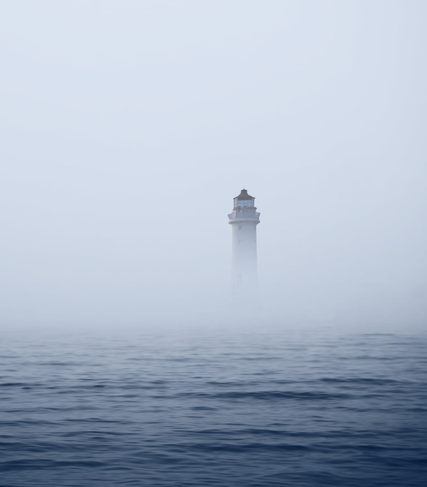 Lighthouse in foggy sea Lighthouse in foggy sea